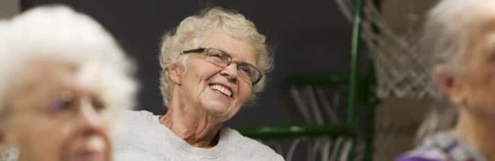 Senior listening to a health seminar at the Oak Park Arms