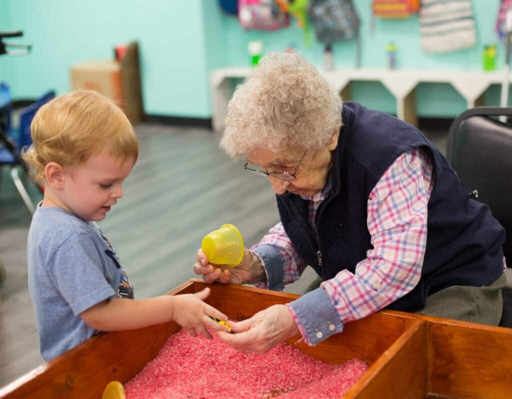 Oak Park Arms Senior plays with Preschooler at Kindness Creators