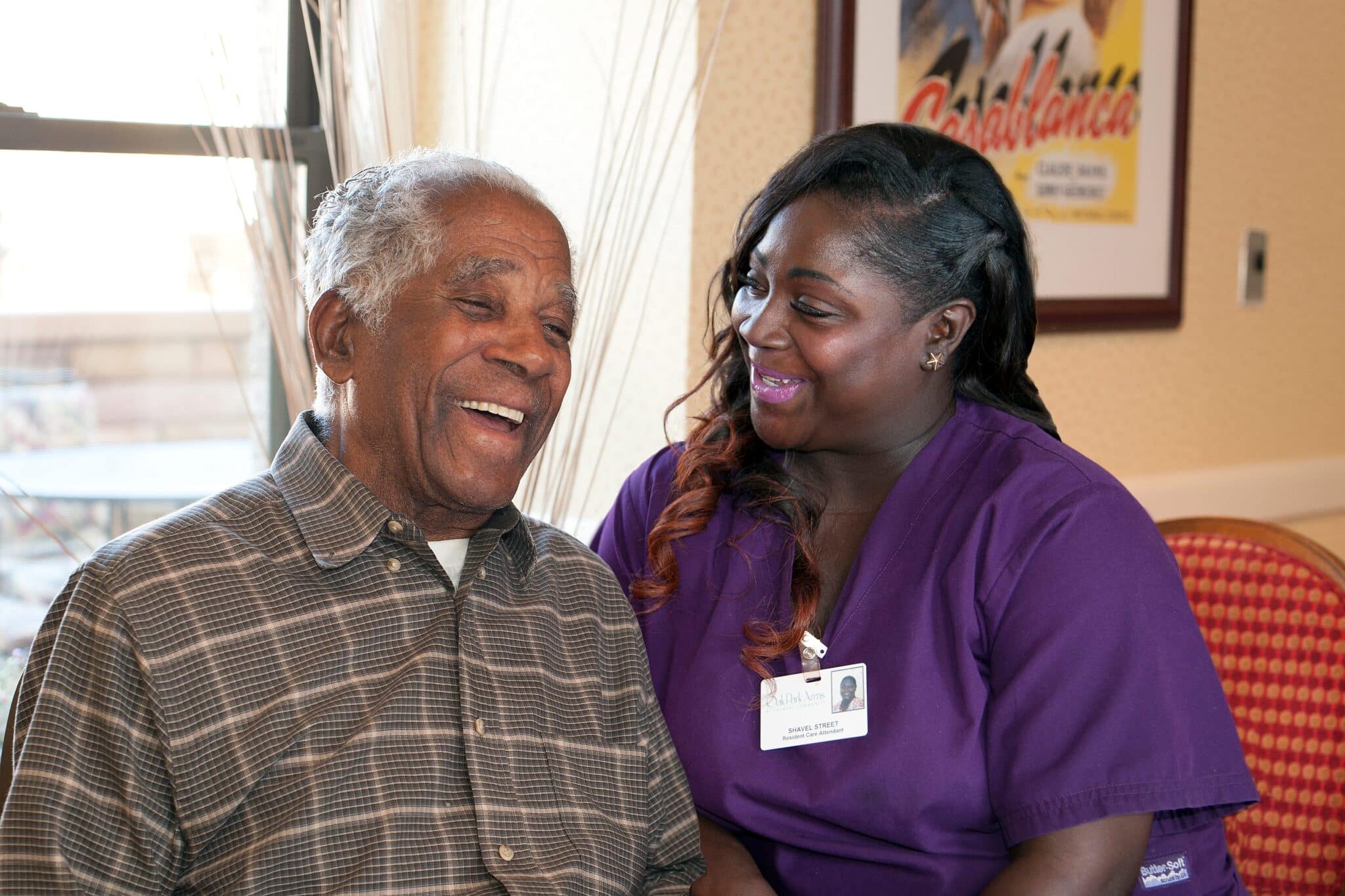 Senior laughing with caregiver