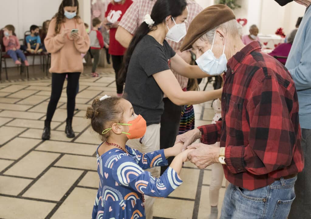 Oak Park Arms resident Donald Vivas dances with Kindness Creators Kayla B. during the Arms Valentines Day Dance Tuesday, February 14, 2023, in Oak Park, Ill.