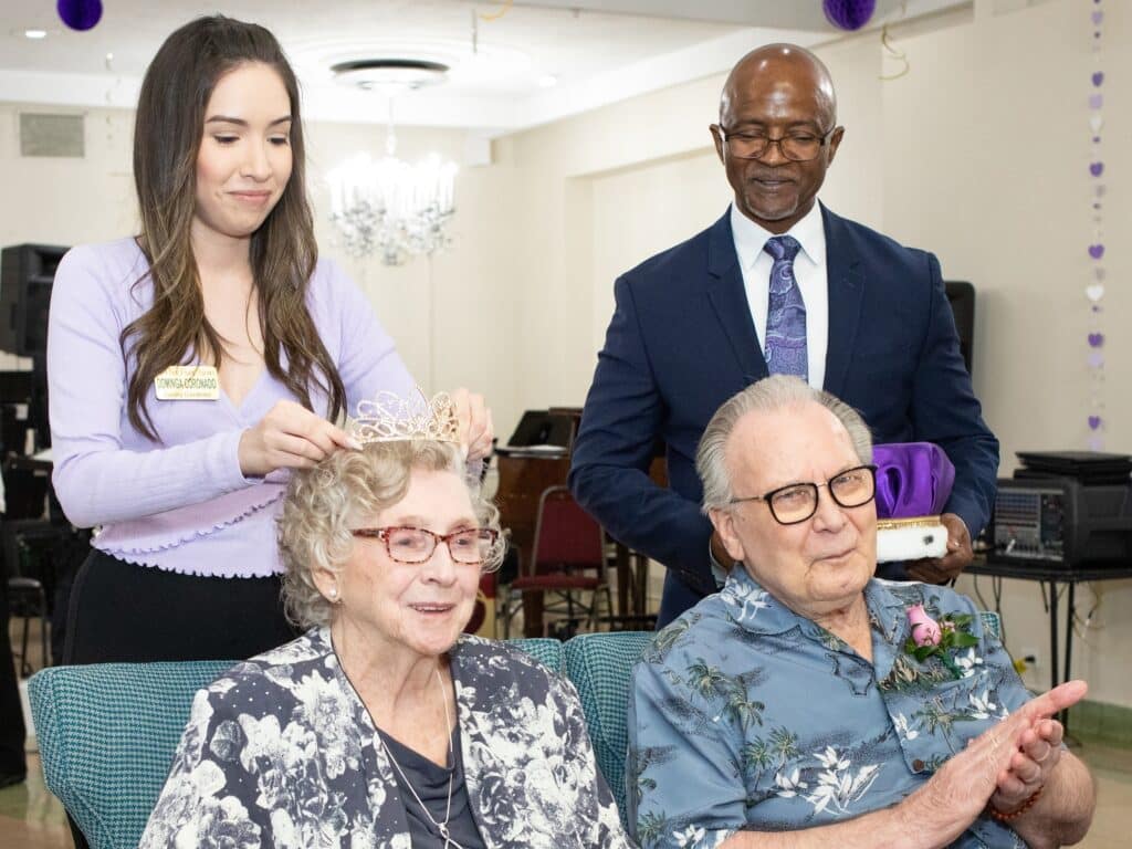 Dominga Coronado, Oak Park Arms leasing coordinator, places the crown on Marge Schwarz, as Moses Williams, Executive Director, and Prom King Don Sundstrom look on during Oak Parks Arms’ 41st annual Seniors’ Senior Prom held Friday, June 16, 2023, in Oak Park.