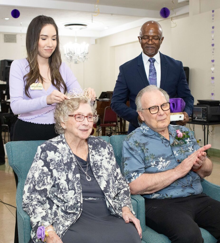 Dominga Coronado, Oak Park Arms leasing coordinator, places the crown on Marge Schwarz, as Moses Williams, Executive Director, and Prom King Don Sundstrom look on during Oak Parks Arms’ 41st annual Seniors’ Senior Prom held Friday, June 16, 2023, in Oak Park