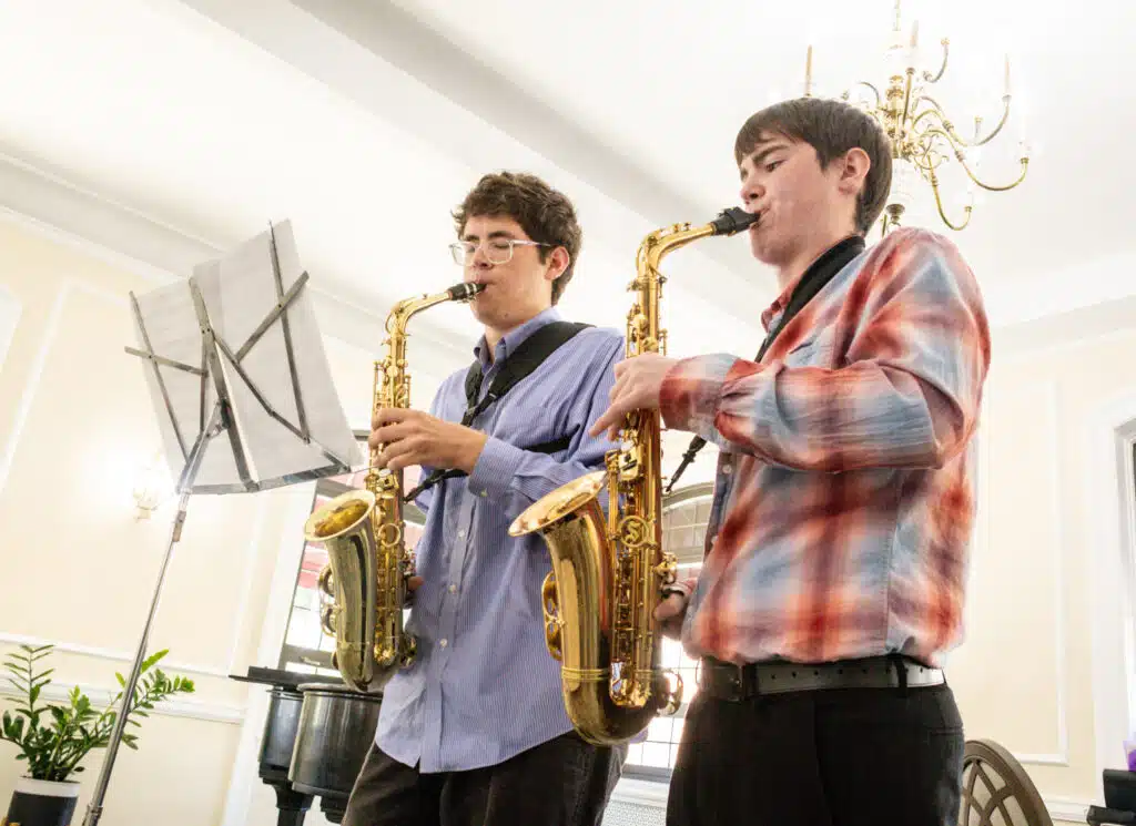 OPRF music students Indi Shannon, left, and Teddy Bell, right, perform a duet at the Oak Park Arms.